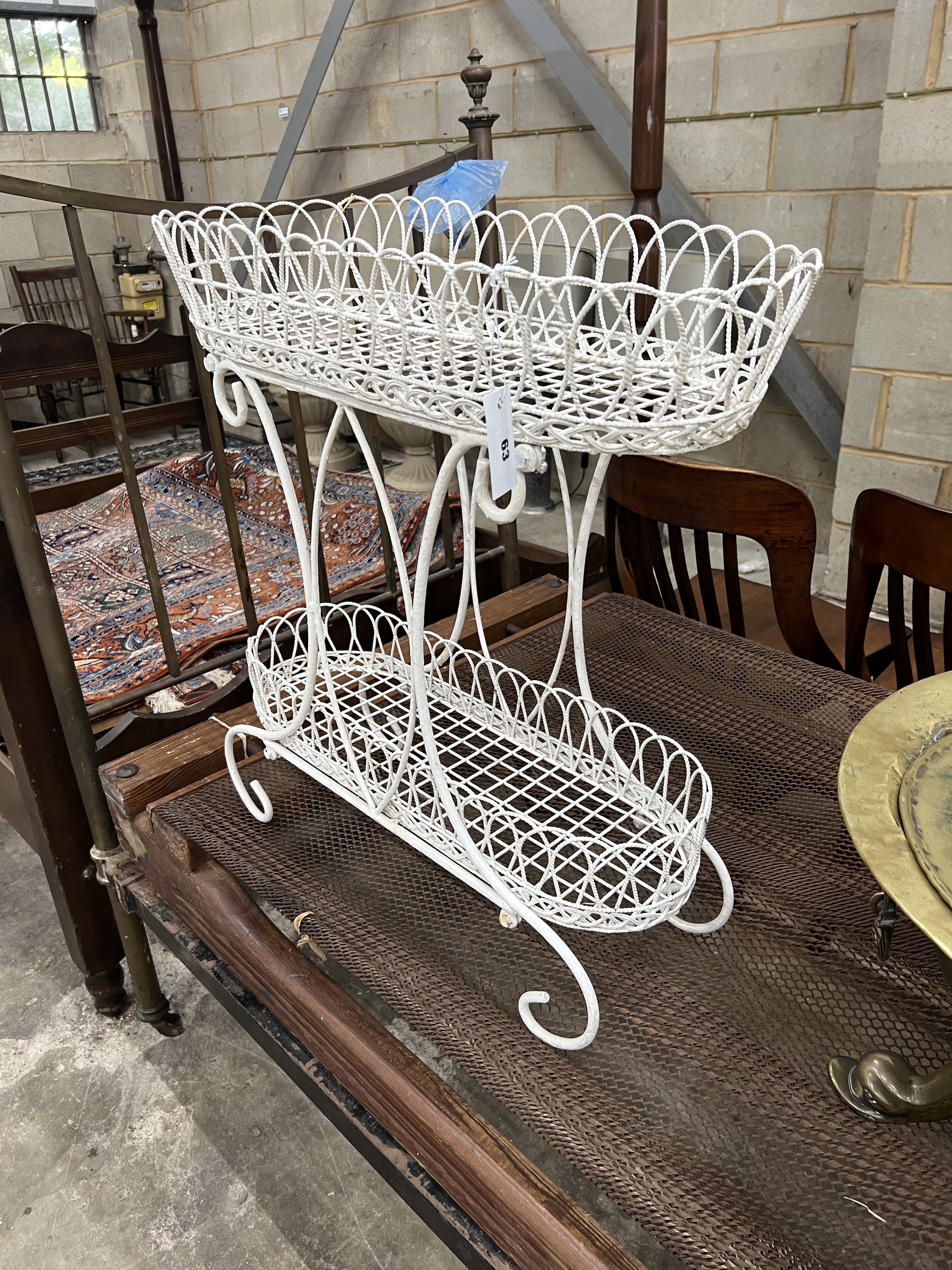 A painted wrought metal two tier pot stand, width 67cm, depth 27cm, height 70cm